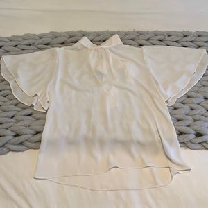 White mock neck top with flutter sleeves
